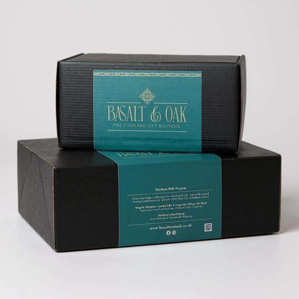 Black hamper box with teal Basalt & Oak label stacked on a white background