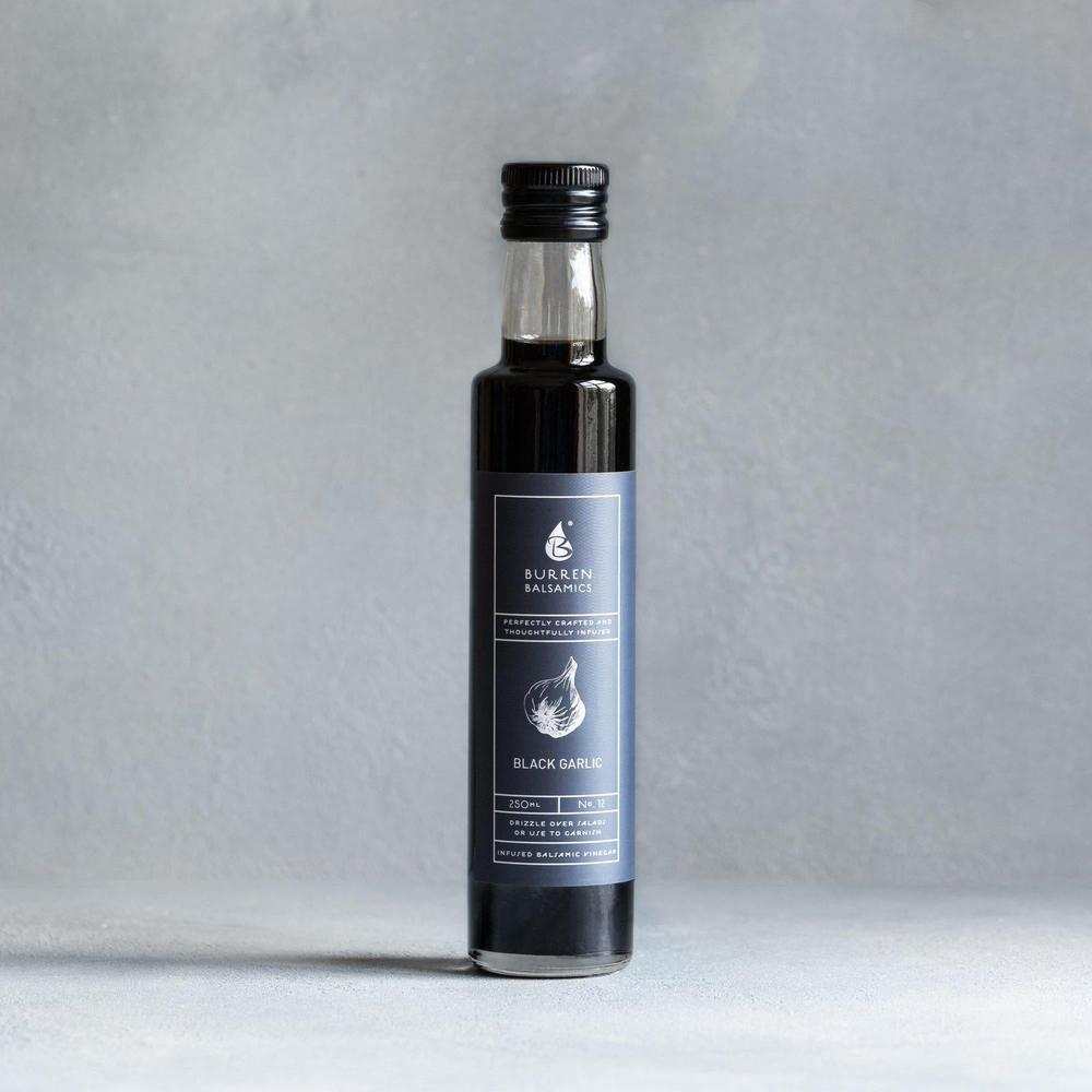 Burren Balsamics 100ml black garlic infused balsamic vinegar bottle on grey background