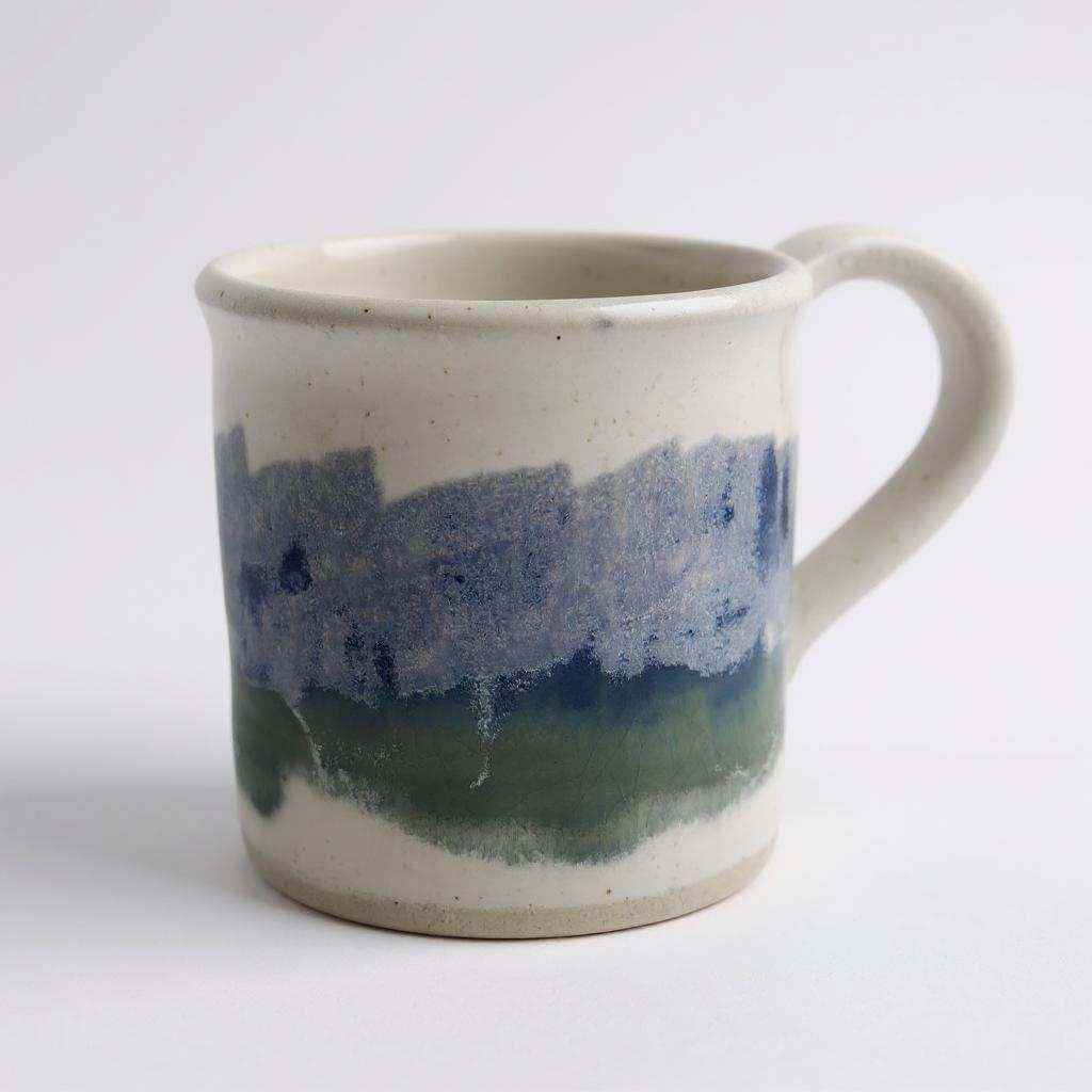 CH Pottery Mug handcrafted with blue, green, and lilac glaze on cream ceramic, dishwasher and microwave safe