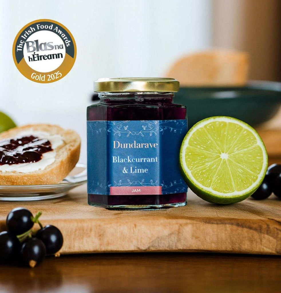 Dundarave Estate Blackcurrant and Lime Jam jar with lime slice and toast background, gold Blas na hÉireann 2025 award badge visible