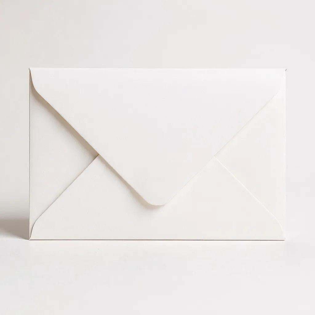 Hand written gift card in plain white envelope isolated on white background
