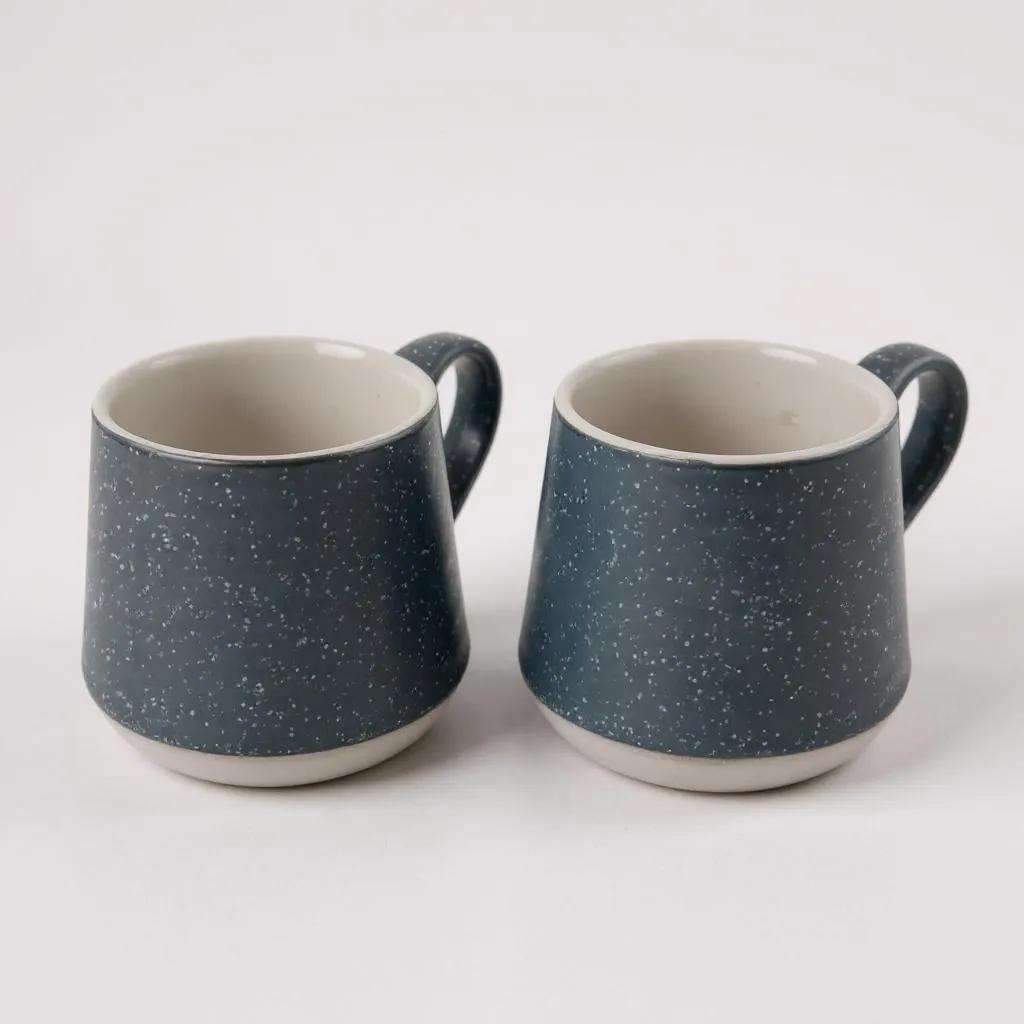 Two unique dark blue speckled SOTG mugs for coffee or tea on white background