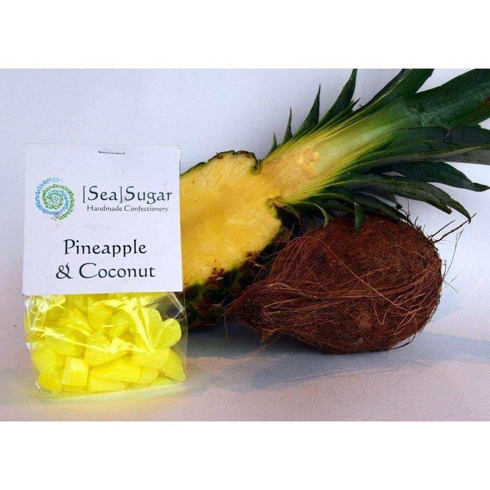 Sea Sugar Pineapple & Coconut Sweets bag with fresh pineapple and coconut on white background