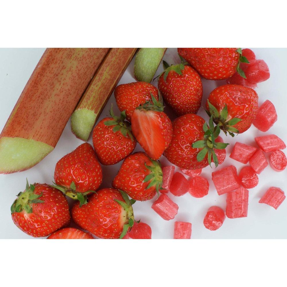 Sea Sugar Rhubarb and Strawberry sweets with fresh rhubarb stalks and ripe strawberries on white background
