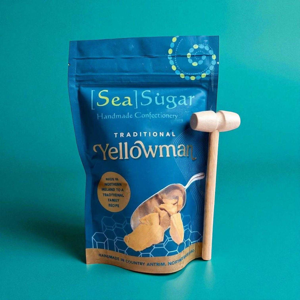 Sea Sugar Traditional Yellowman hard brittle confectionery in blue packaging with wooden hammer.