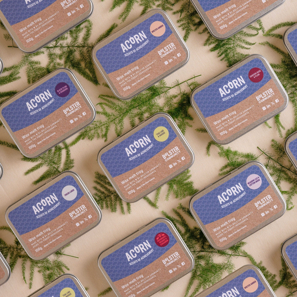 Multiple Acorn Wax Melts Tins with eco-friendly soy wax melt discs and natural fern leaves background